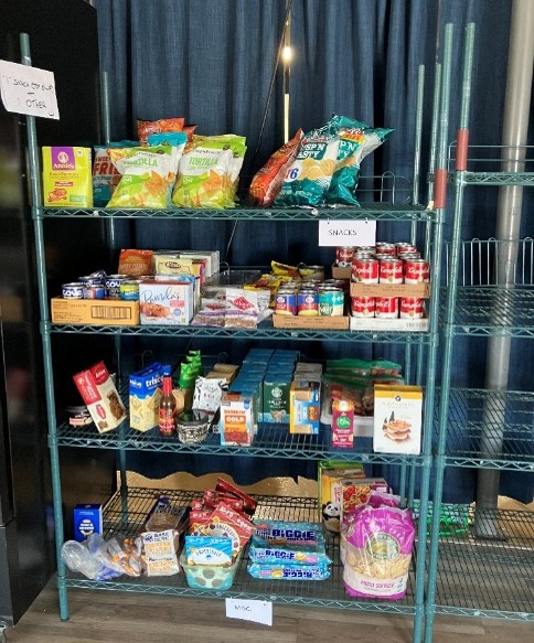 Shelves with pantry items, such as chips, soup cans, and crackers